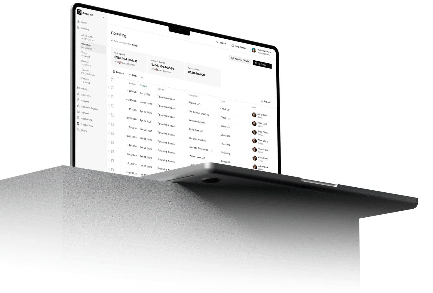 A laptop displaying a data management dashboard with various columns and rows, placed on a gray concrete block.