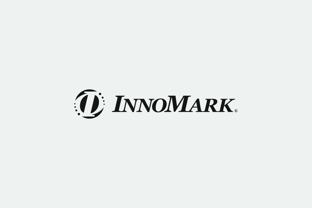 Logo of InnoMark featuring a stylized "I" with dotted circle design on a light gray background.