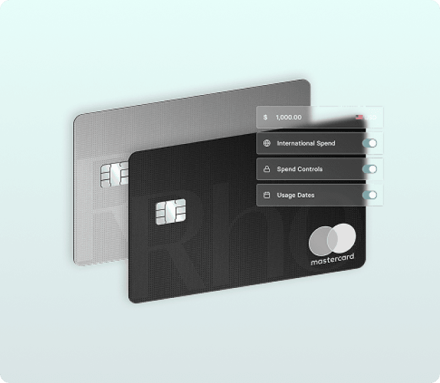 Two credit cards, one black and one gray, with a Mastercard logo. Overlay shows spend controls for international use and usage dates.