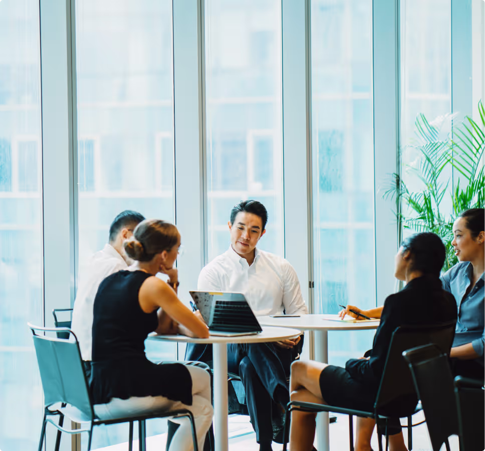 Several people sitting around over a computer.